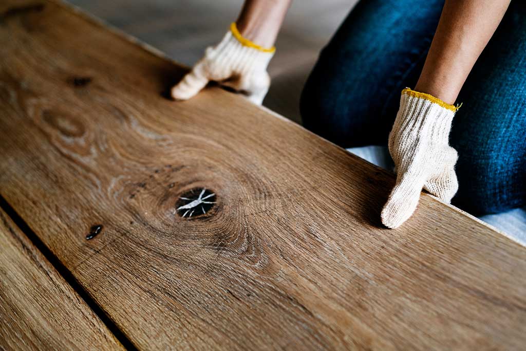Flooring installer putting down hardwood planks during Hardwood Floor Installation Kansas City