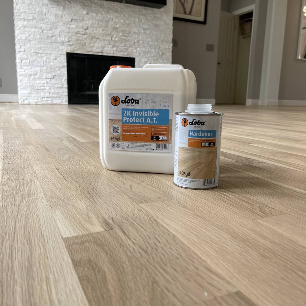 Stain bottled pictured with hardwood floor after stain application and completion