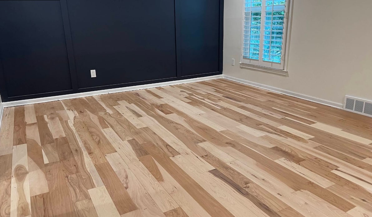 Wood floor repair underway in a room with natural light, Kansas City KS, new mixed hardwood planks